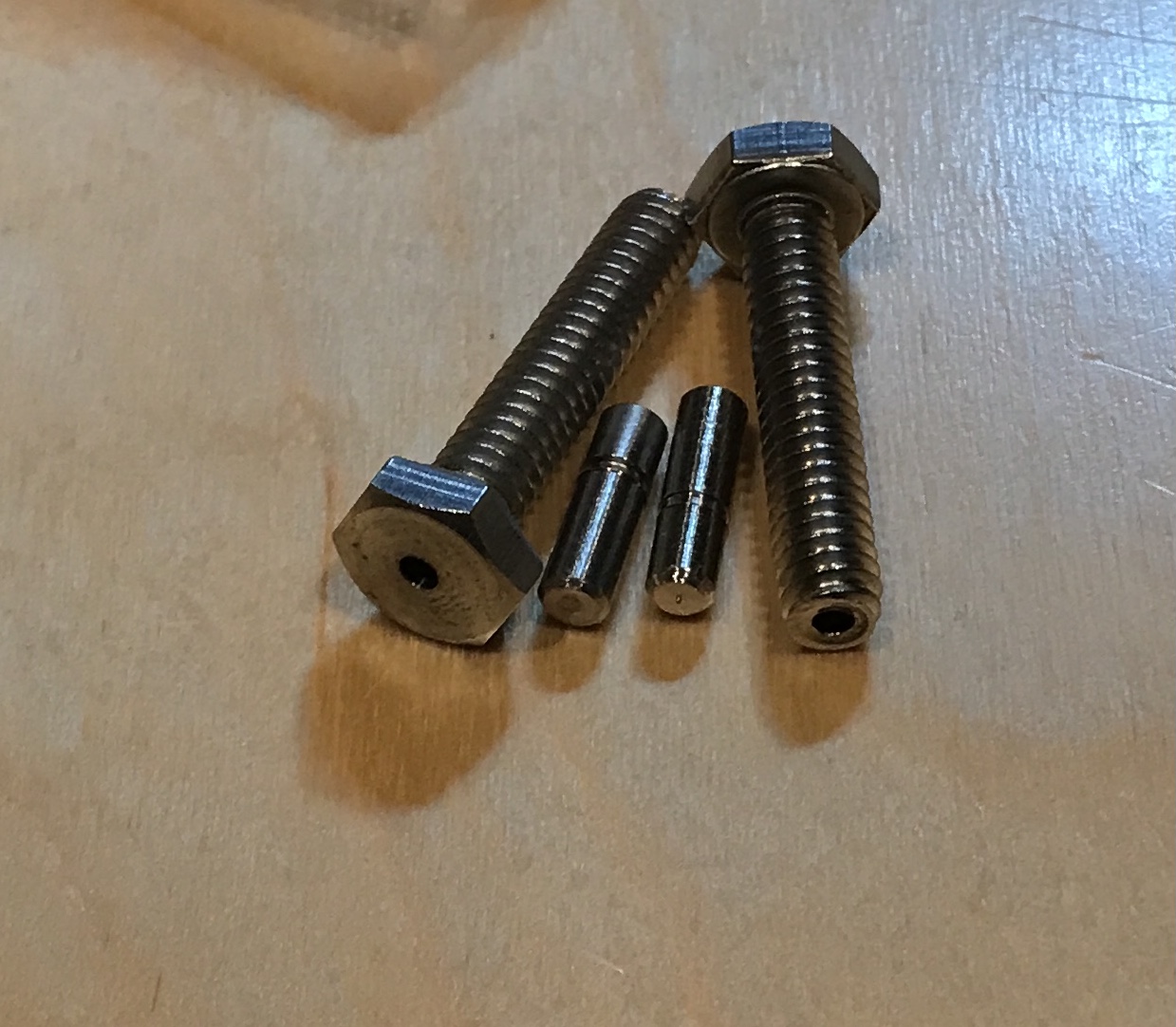 Two pins and two drilled screws